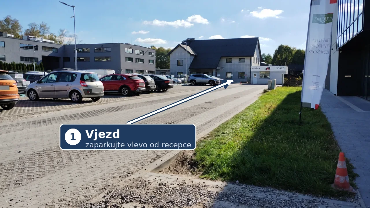 Příjezd k bílé recepci s nápisem WEJŚCIE